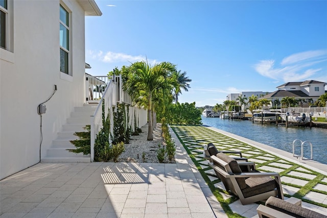 exterior space with a water view and stairway