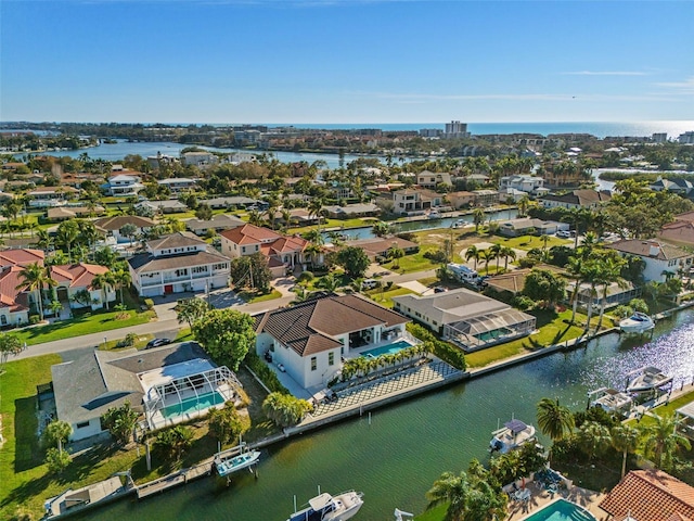 drone / aerial view with a water view and a residential view