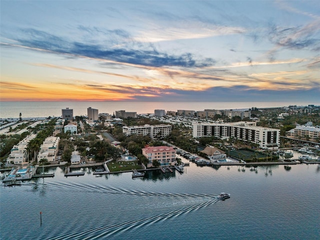 aerial view at dusk with a water view and a view of city
