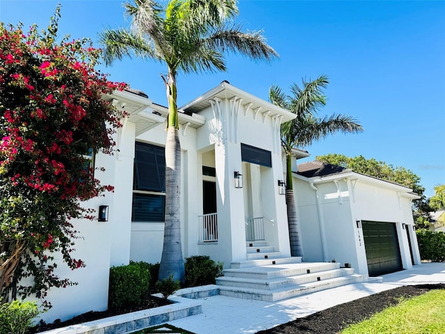 view of front of property with an attached garage and stucco siding