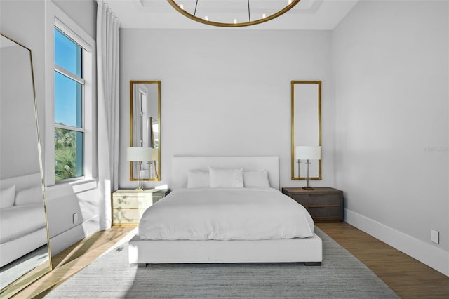 bedroom with baseboards and wood finished floors
