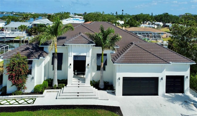 1643 Stanford Ln, Sarasota, FL 34231 - view of front of property featuring a tiled roof, stucco siding, an attached garage, and driveway