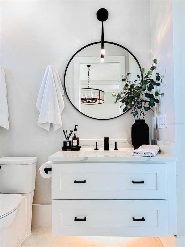 1643 Stanford Ln, Sarasota, FL 34231 - bathroom with vanity, marble look tile flooring, and a chandelier