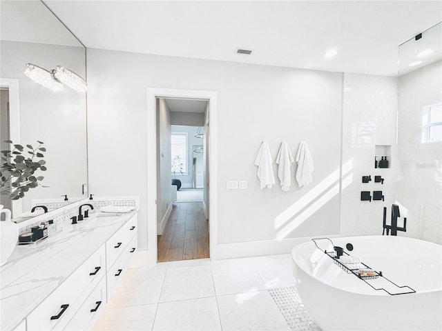 1643 Stanford Ln, Sarasota, FL 34231 - bathroom with a soaking tub, double vanity, and recessed lighting