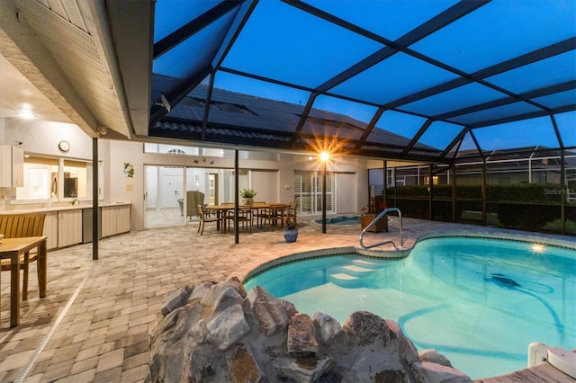 outdoor pool featuring a patio, outdoor dining area, and a lanai