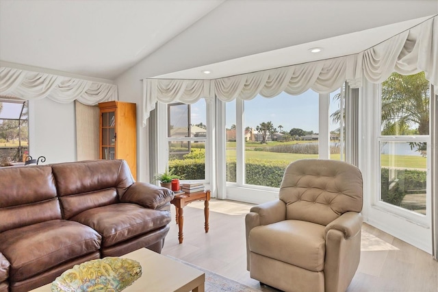 living room featuring vaulted ceiling, recessed lighting, and a wealth of natural light