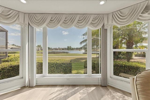 unfurnished sunroom featuring a water view and recessed lighting