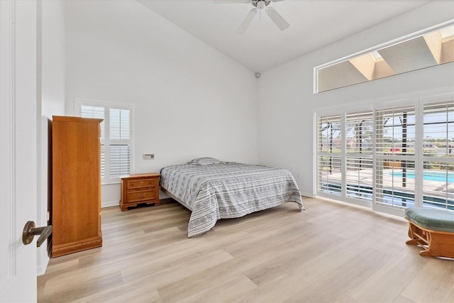 bedroom featuring high vaulted ceiling, a ceiling fan, and wood finished floors