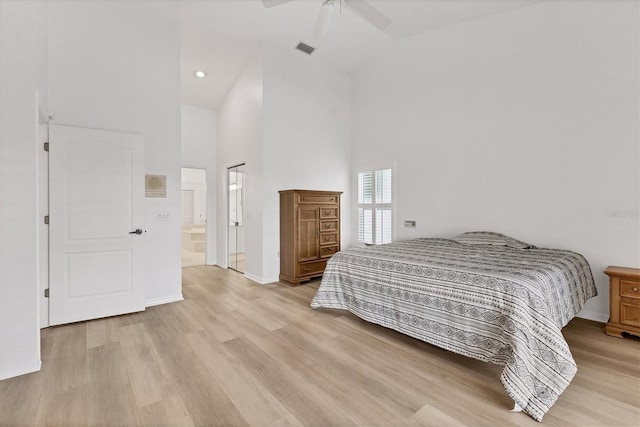bedroom featuring light wood-style floors, high vaulted ceiling, baseboards, and visible vents