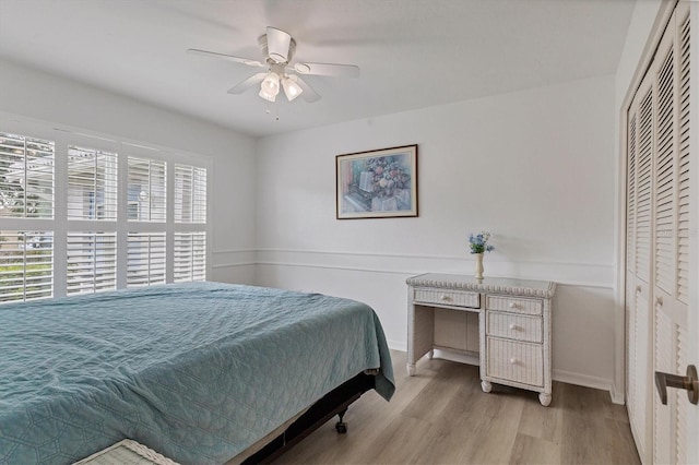 bedroom with baseboards, ceiling fan, and wood finished floors