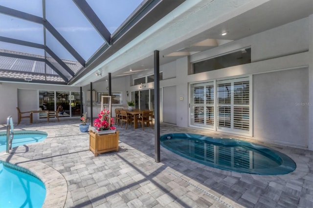 pool with a patio, outdoor dining area, and a lanai