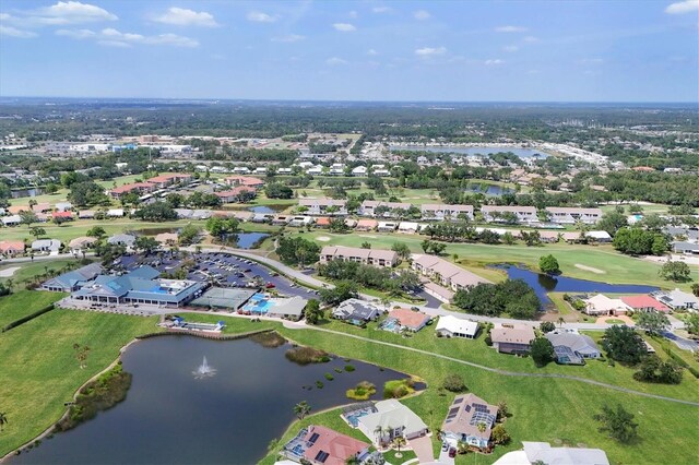drone / aerial view with a residential view, a water view, and golf course view
