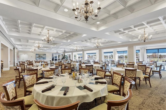dining area with light colored carpet, coffered ceiling, a chandelier, and a wealth of natural light