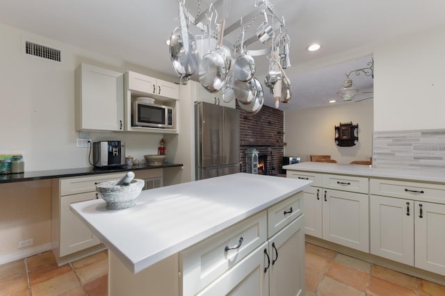 2723 59th St, Sarasota, FL 34243 - kitchen with visible vents, appliances with stainless steel finishes, a fireplace, a chandelier, and recessed lighting