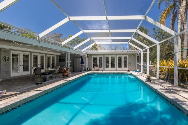 2723 59th St, Sarasota, FL 34243 - outdoor pool featuring a patio, glass enclosure, and french doors