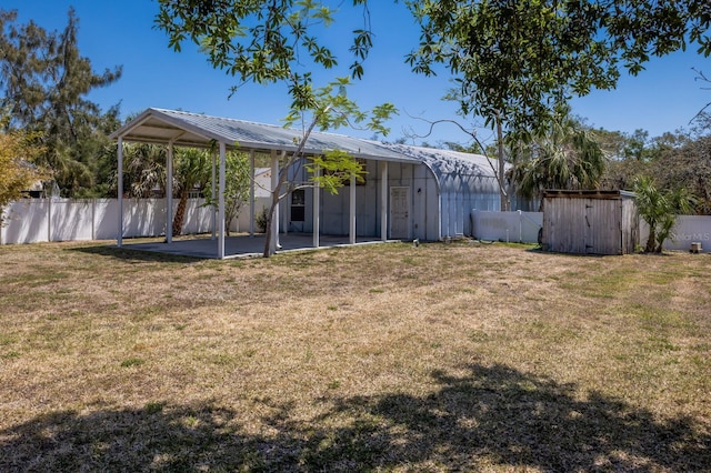 2723 59th St, Sarasota, FL 34243 - view of yard with a fenced backyard, a storage unit, and a patio