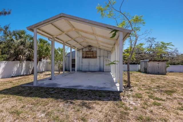2723 59th St, Sarasota, FL 34243 - view of parking featuring a fenced backyard and a shed