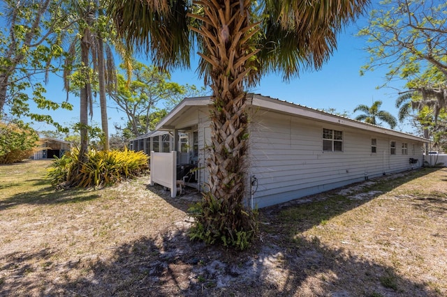 2723 59th St, Sarasota, FL 34243 - view of side of home featuring a sunroom