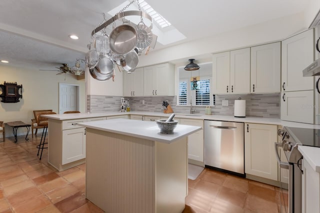 2723 59th St, Sarasota, FL 34243 - kitchen featuring a center island, light countertops, appliances with stainless steel finishes, and tasteful backsplash