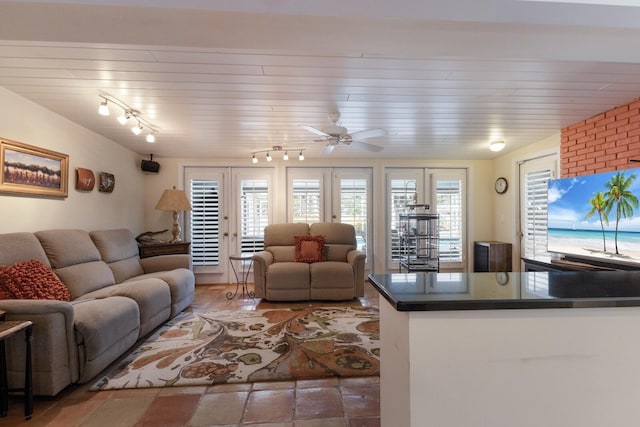 2723 59th St, Sarasota, FL 34243 - living area featuring a ceiling fan, rail lighting, and stone tile flooring