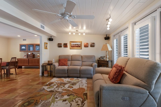 2723 59th St, Sarasota, FL 34243 - living room featuring visible vents, rail lighting, wood ceiling, and ceiling fan