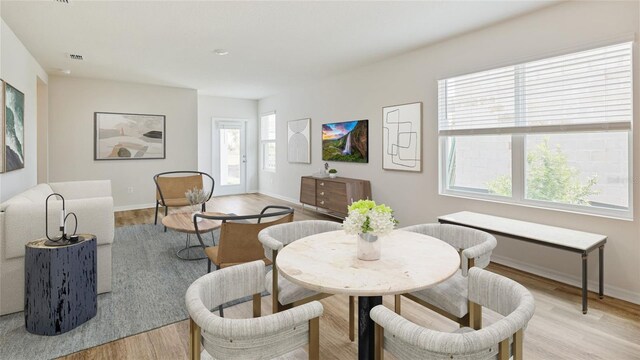 5030 Rocky Coast Pl, Palmetto, FL 34221 - dining area with baseboards and light wood-style flooring