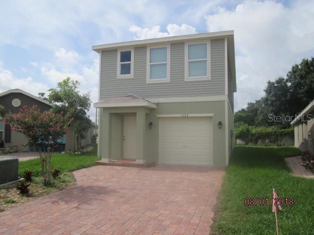 view of front of property with a garage, stucco siding, and decorative driveway