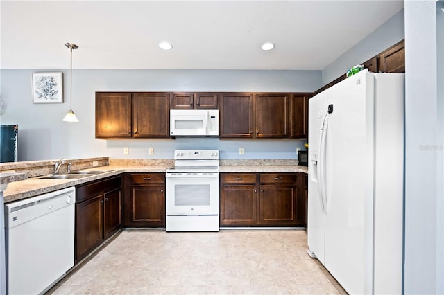 1122 42nd Ter E, Bradenton, FL 34208 - kitchen with white appliances, a sink, dark brown cabinetry, light countertops, and pendant lighting