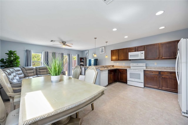 1122 42nd Ter E, Bradenton, FL 34208 - kitchen featuring white appliances, open floor plan, light countertops, a sink, and recessed lighting