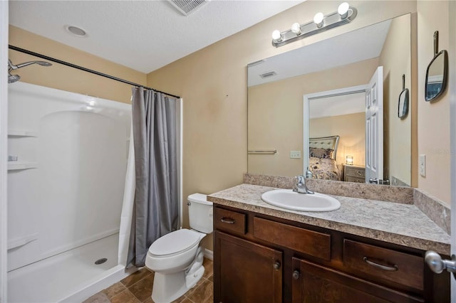 1122 42nd Ter E, Bradenton, FL 34208 - ensuite bathroom featuring a shower stall, toilet, vanity, and tile patterned flooring