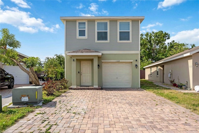 1122 42nd Ter E, Bradenton, FL 34208 - view of front of property with decorative driveway, stucco siding, and an attached garage