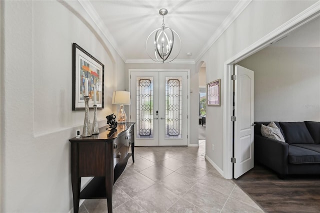 13587 Vancanza Dr, Venice, FL 34293 - entryway featuring french doors, crown molding, arched walkways, tile patterned floors, and a notable chandelier