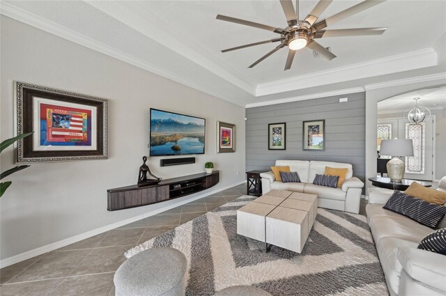 13587 Vancanza Dr, Venice, FL 34293 - tiled living room featuring crown molding, arched walkways, a raised ceiling, and ceiling fan