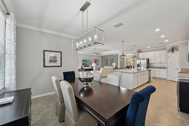 13587 Vancanza Dr, Venice, FL 34293 - dining area with crown molding, light tile patterned floors, ceiling fan, and visible vents