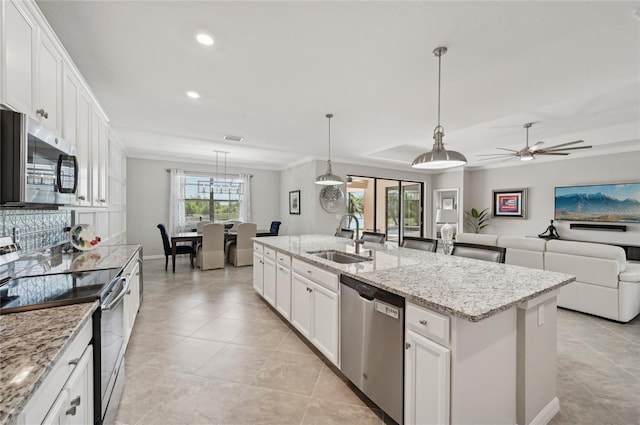 13587 Vancanza Dr, Venice, FL 34293 - kitchen featuring white cabinets, a ceiling fan, appliances with stainless steel finishes, and a sink