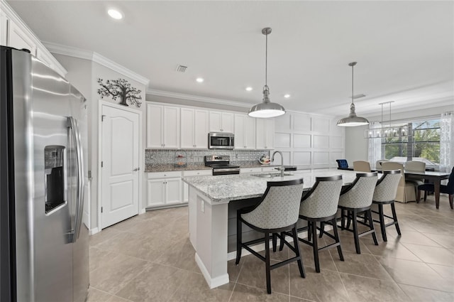 13587 Vancanza Dr, Venice, FL 34293 - kitchen with visible vents, a sink, white cabinets, ornamental molding, and stainless steel appliances