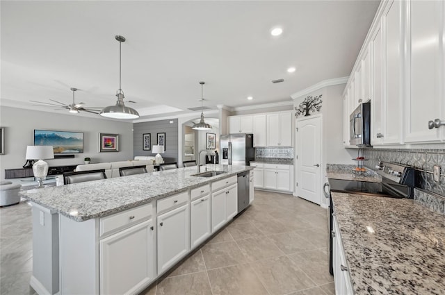 13587 Vancanza Dr, Venice, FL 34293 - kitchen with a ceiling fan, open floor plan, tasteful backsplash, a sink, and stainless steel appliances