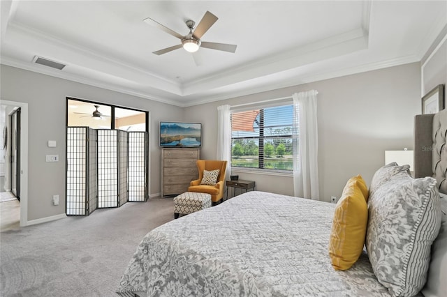 13587 Vancanza Dr, Venice, FL 34293 - bedroom with visible vents, ornamental molding, baseboards, a tray ceiling, and carpet flooring