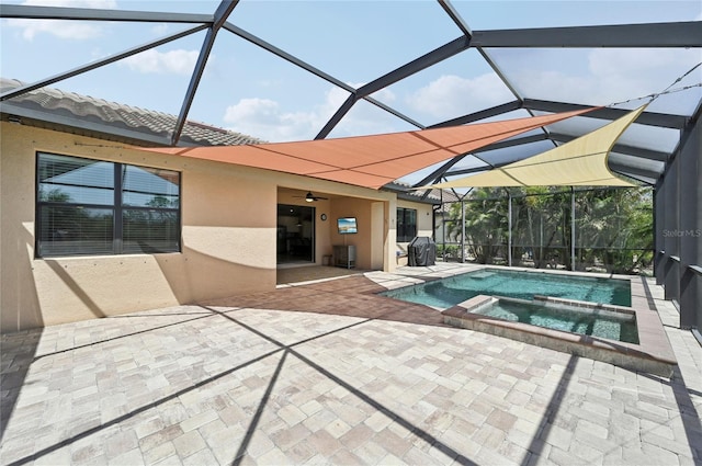 13587 Vancanza Dr, Venice, FL 34293 - view of swimming pool with a patio, a ceiling fan, glass enclosure, and a pool with connected hot tub