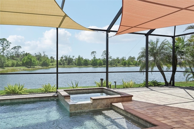 13587 Vancanza Dr, Venice, FL 34293 - view of swimming pool featuring glass enclosure, a water view, a pool with connected hot tub, and a patio