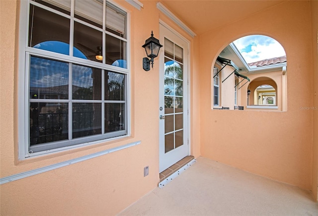entrance to property featuring stucco siding