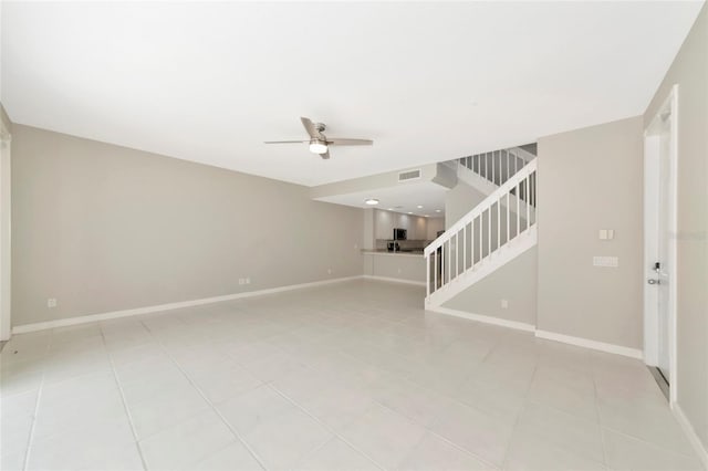 unfurnished living room with visible vents, baseboards, stairway, a ceiling fan, and light tile patterned floors