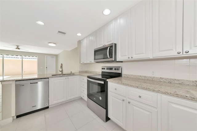 kitchen featuring a sink, stainless steel appliances, white cabinetry, a peninsula, and visible vents