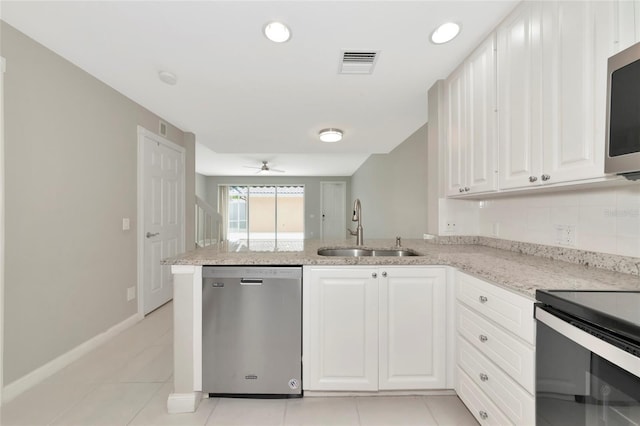 kitchen with visible vents, appliances with stainless steel finishes, light stone countertops, a sink, and a peninsula