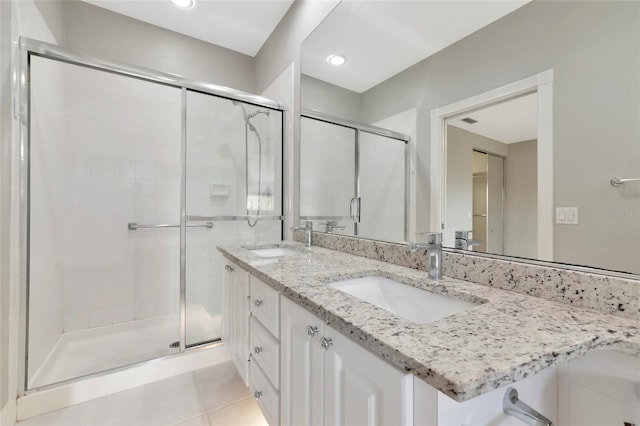 full bath with a sink, a stall shower, and tile patterned floors