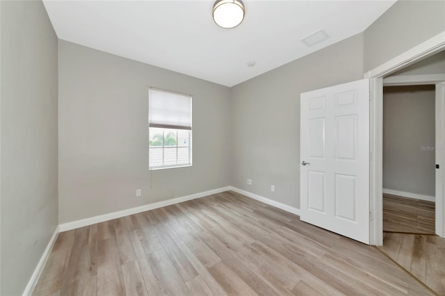 unfurnished bedroom featuring baseboards and light wood-type flooring