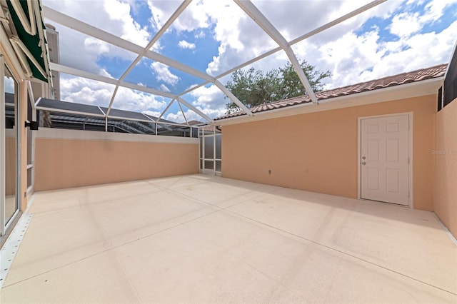 view of patio with glass enclosure