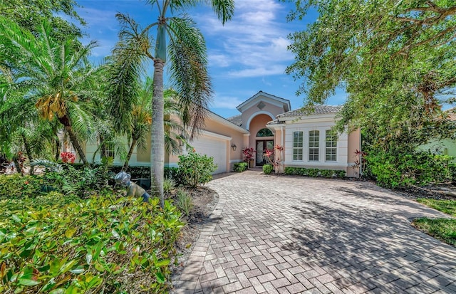 7624 Boltons Ct, Bradenton, FL 34201 - view of front facade with stucco siding, french doors, an attached garage, and driveway