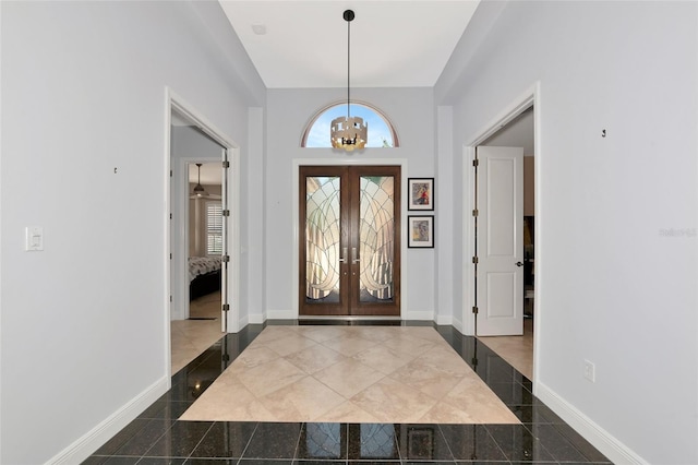 7624 Boltons Ct, Bradenton, FL 34201 - foyer with a chandelier, granite floors, french doors, and baseboards
