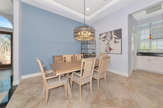 7624 Boltons Ct, Bradenton, FL 34201 - dining space featuring a chandelier, baseboards, a raised ceiling, and light tile patterned floors